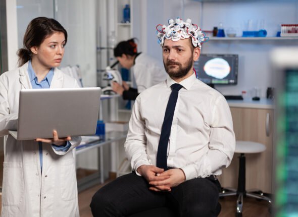Researcher woman doctor typing neurological disease symptoms on laptop